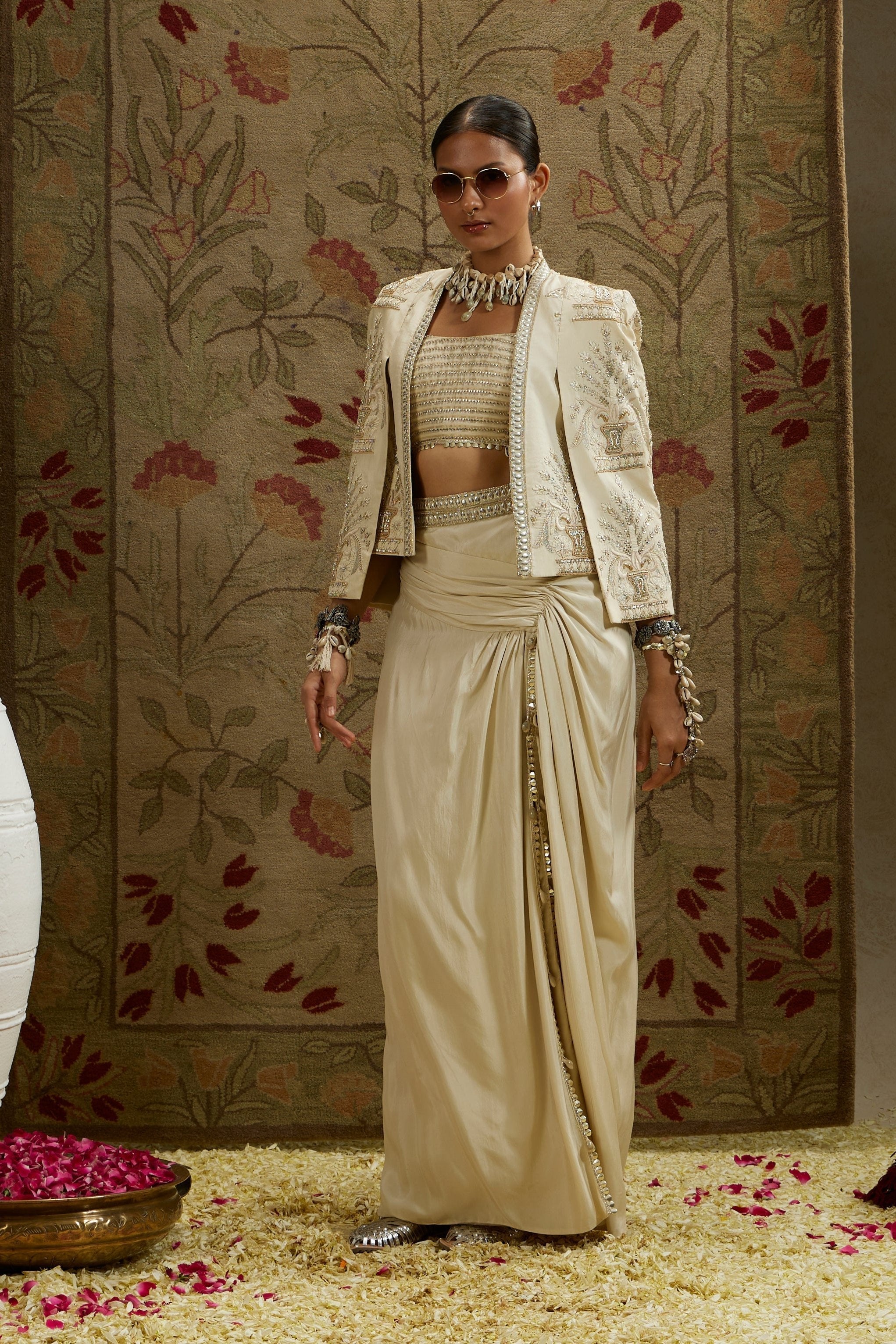 MAGNOLIA EMBELLISHED BUTTA CAPE JACKET PAIRED WITH METAL EMBELLISHED BUSTIER AND SLIT SKIRT