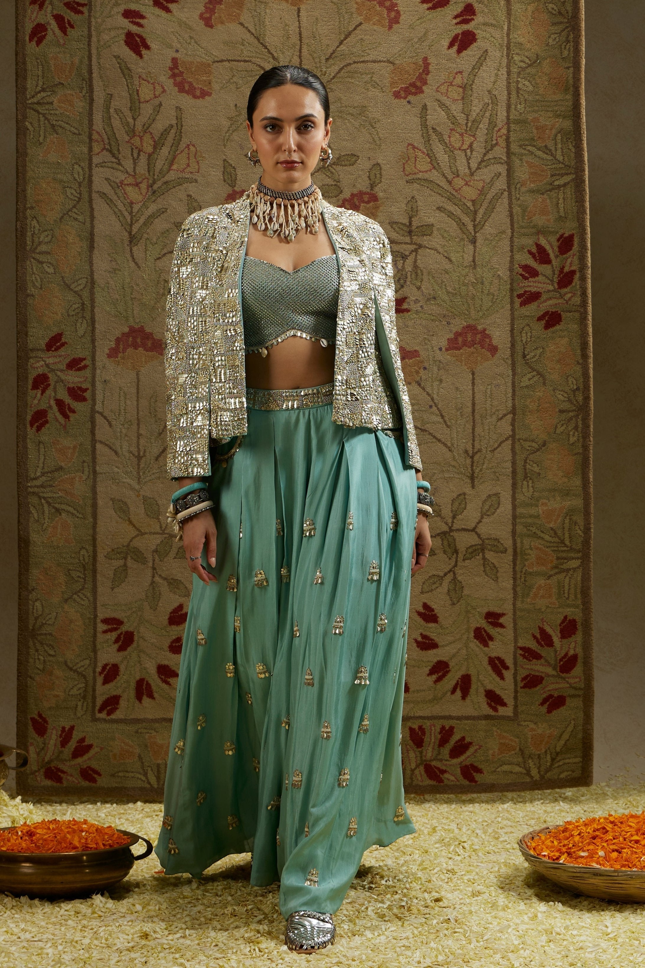 METALLIC NOOR JACKET PAIRED WITH METALLIC BUSTIER AND EMBELLISHED PLEATED PANTS