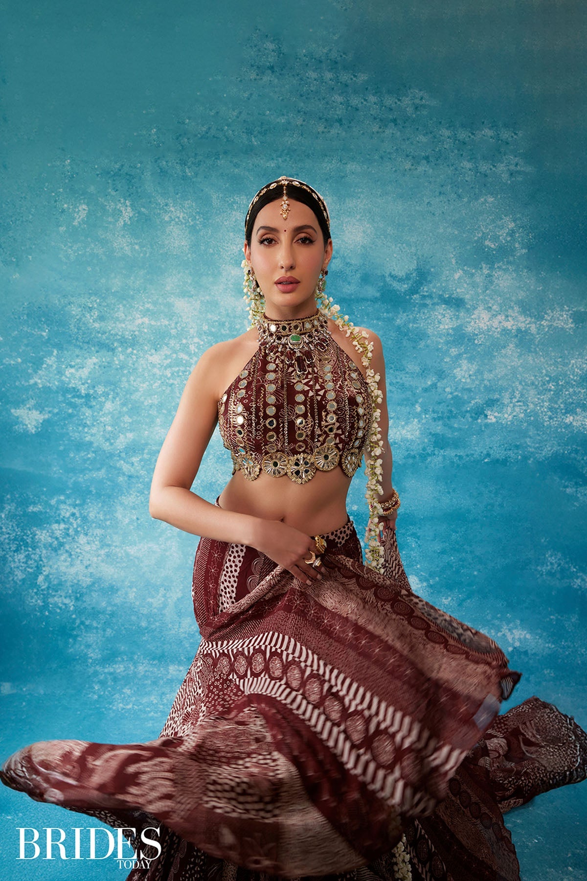Nora Fatehi in Maroon Print and Highlighted Mermaid Saree Set