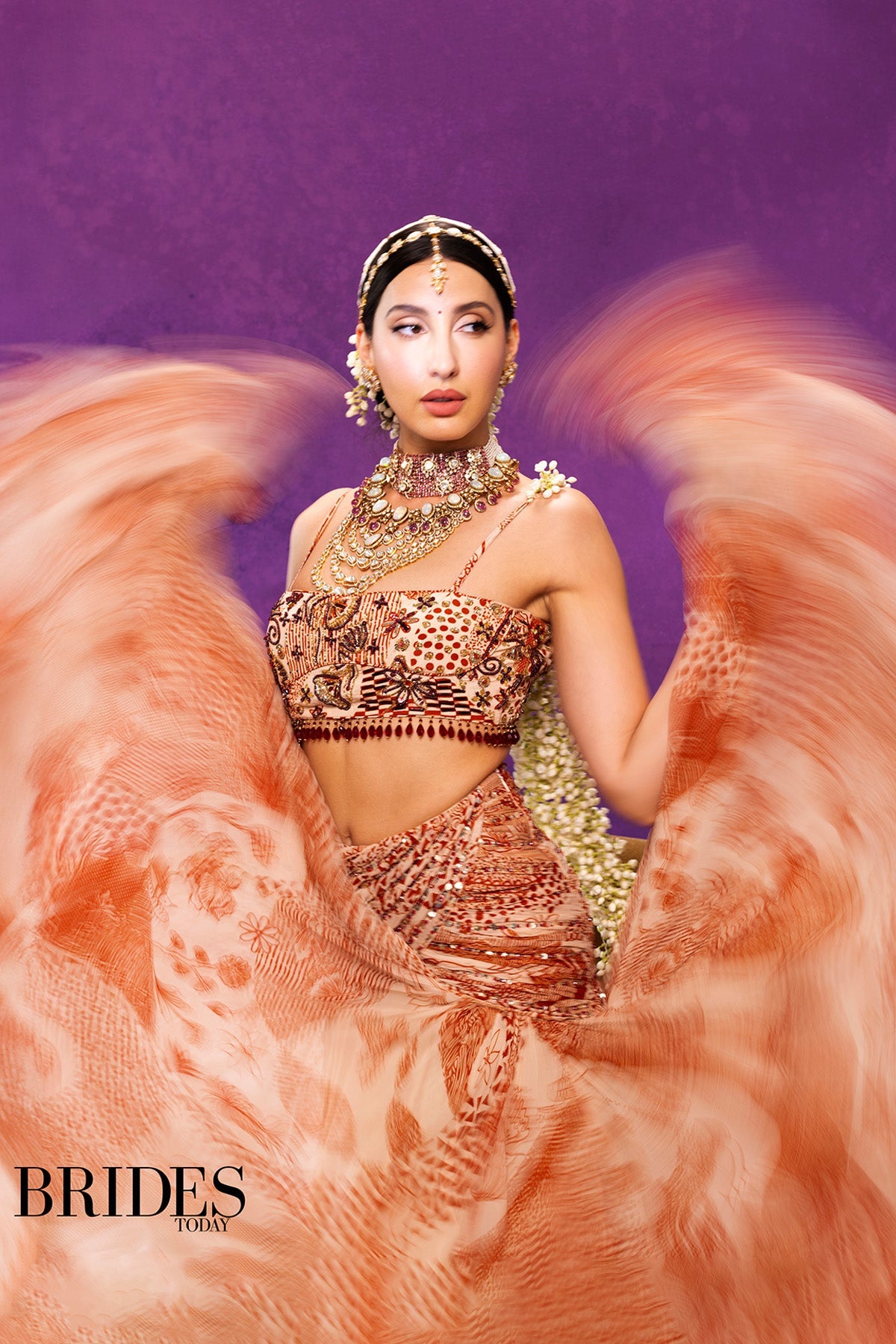 Nora Fatehi in Beige & Rust Print and Highlighted Lehenga Set