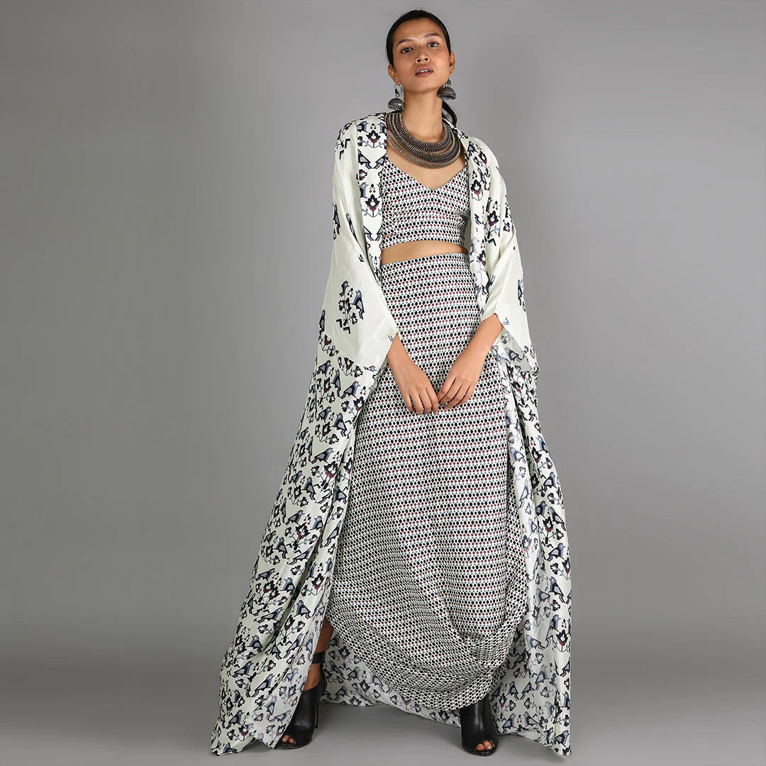 WHITE JAALI PRINT BUSTIER AND DRAPE SKIRT PAIRED WITH WHITE HALF BIRD PRINT AND HALF GEOMETRIC DAMASK PRINT CAPE