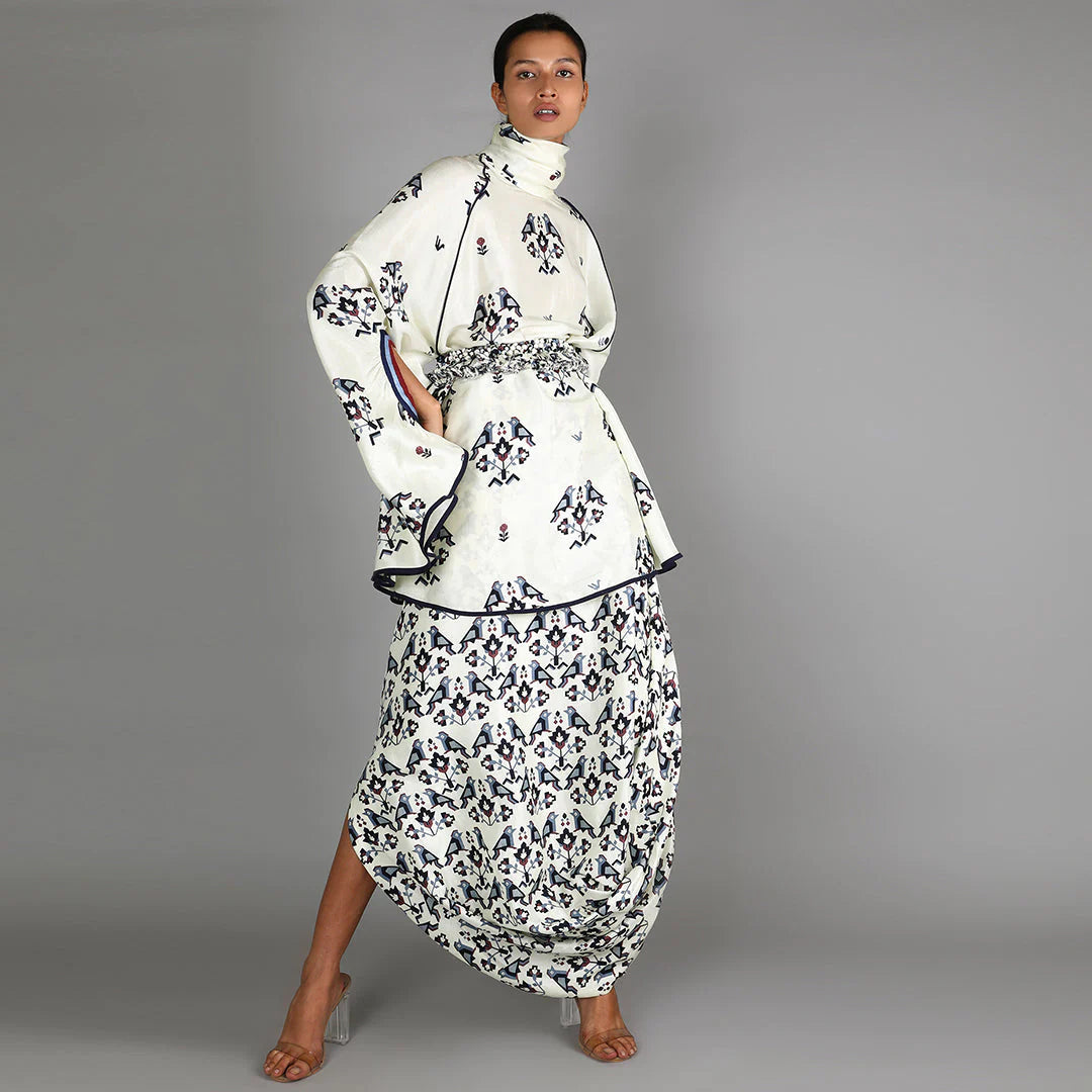 WHITE BIRD PRINT TURTLE NECK CAPE TOP PAIRED WITH WHITE GEOMETRIC DAMASK PRINT DRAPE SKIRT