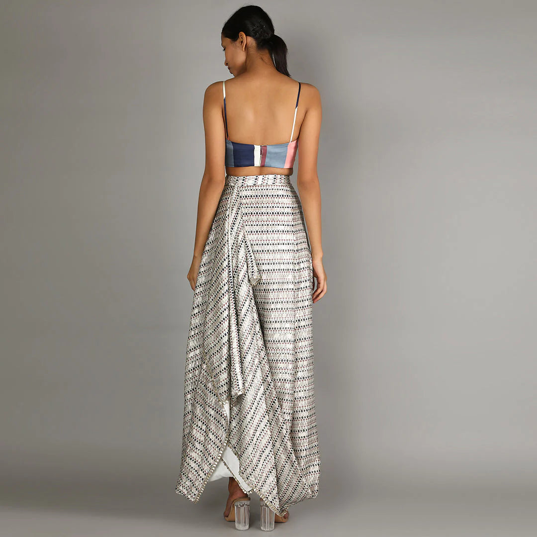 WHITE JAALI PRINT CHANDERI DRAPE SKIRT AND CAPE PAIRED WITH STRIPE PRINT BUSTIER