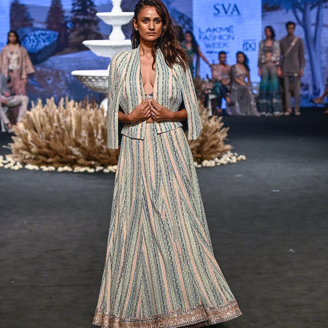 STRIPE PRINTED LUCKNOWI LEHNGA TEAMED WITH A PATCHWORK CORSET AND STRUCTURED CAPE JACKET
