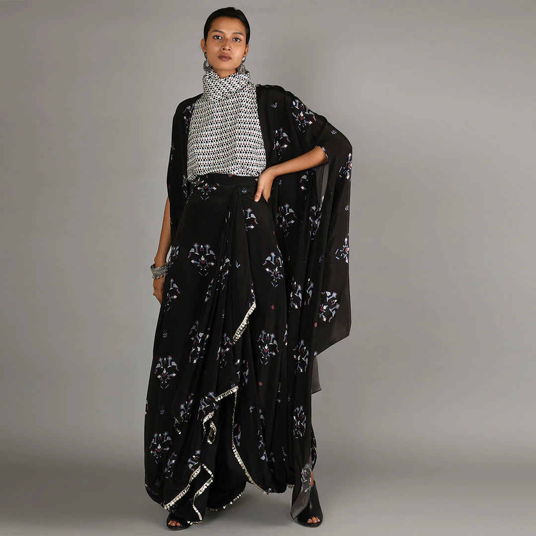 JAALI PRINT WHITE TURTLE NECK TOP PAIRED WITH BLACK BIRD PRINT DRAPE SKIRT WITH CAPE