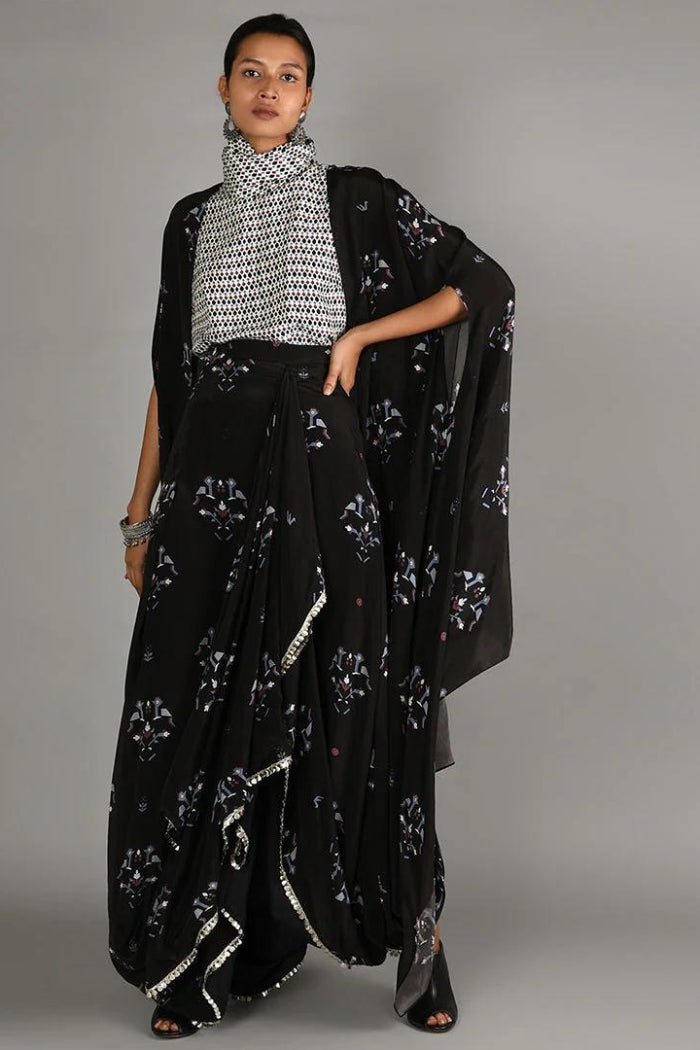 JAALI PRINT WHITE TURTLE NECK TOP PAIRED WITH BLACK BIRD PRINT DRAPE SKIRT WITH CAPE
