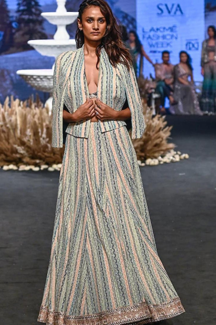 STRIPE PRINTED LUCKNOWI LEHNGA TEAMED WITH A PATCHWORK CORSET AND STRUCTURED CAPE JACKET