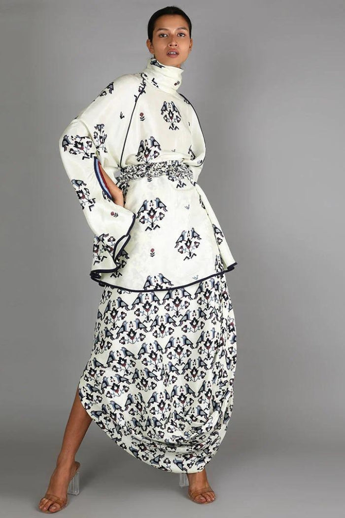 WHITE BIRD PRINT TURTLE NECK CAPE TOP PAIRED WITH WHITE GEOMETRIC DAMASK PRINT DRAPE SKIRT
