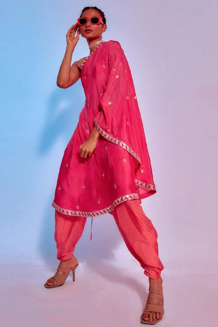 EMBELLISHED CORAL ONE SHOULDER DRAPED KURTA TEAMED WITH CORAL DRAPED PANTS