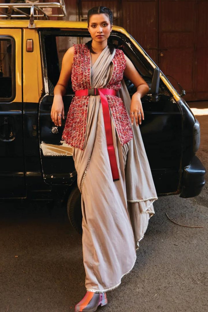 CONCRETE GREY PRE STITCHED CASCASE SAREE TEAMED WITH BUSTIER AND EMBELLISHED JACKET BELT: STYLING PURPOSE ONLY