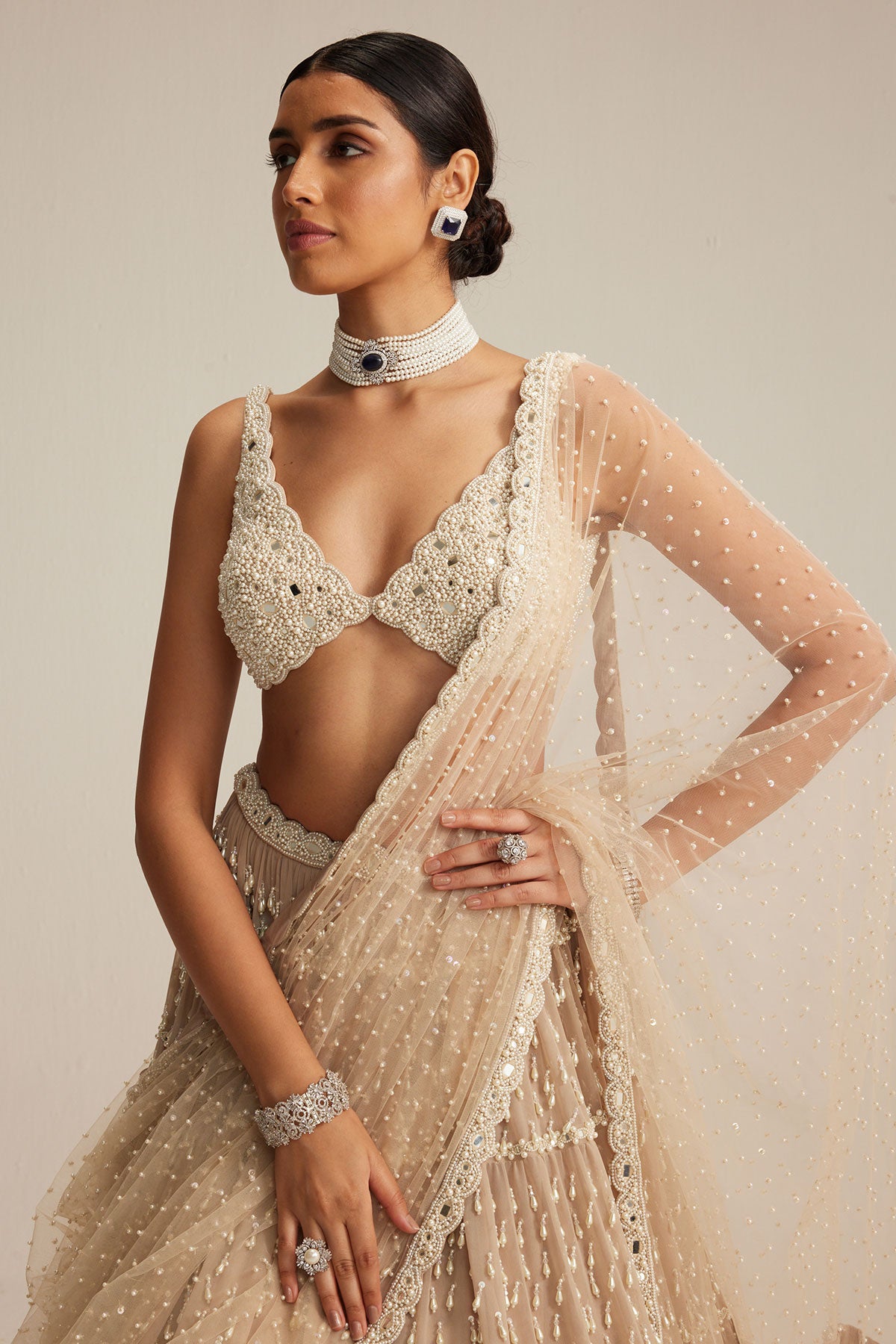 Light Beige Pearl Drop Multi Tier Lehenga Set.