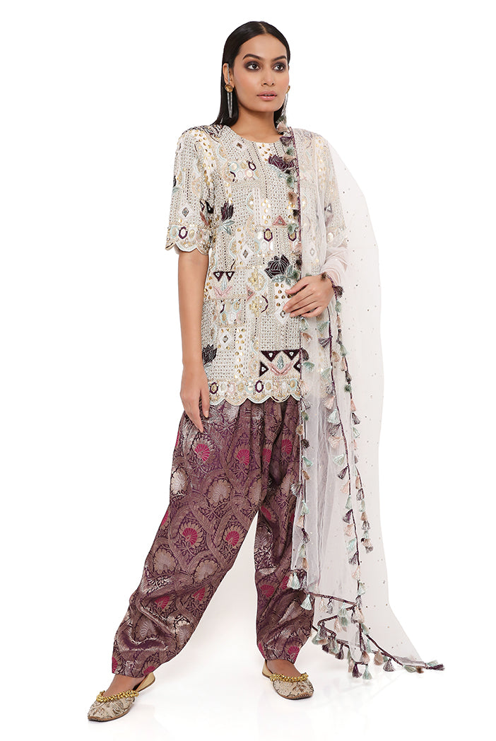 OFF WHITE GEORGETTE EMBROIDERED KURTA WITH PURPLE BROCADE SALWAR AND OFF WHITE MUKAISH NET DUPATTA