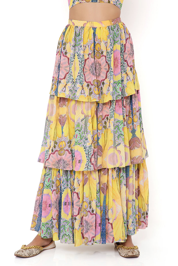 YELLOW ENCHANTED PRINT GEORGETTE EMBROIDERED ONE SHOULDER CAPE WITH BUSTIER AND FRILL SHARARA