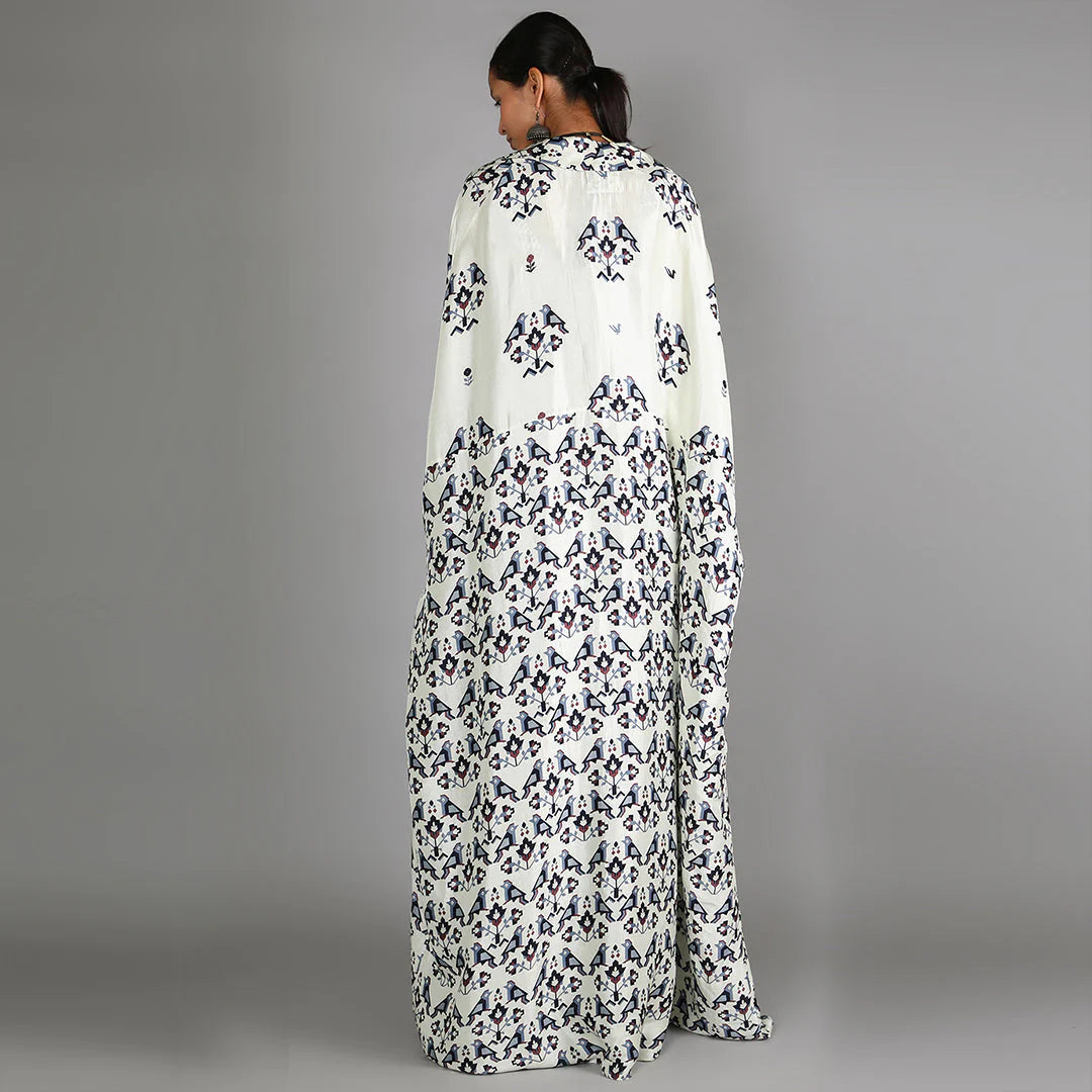 WHITE JAALI PRINT BUSTIER AND DRAPE SKIRT PAIRED WITH WHITE HALF BIRD PRINT AND HALF GEOMETRIC DAMASK PRINT CAPE