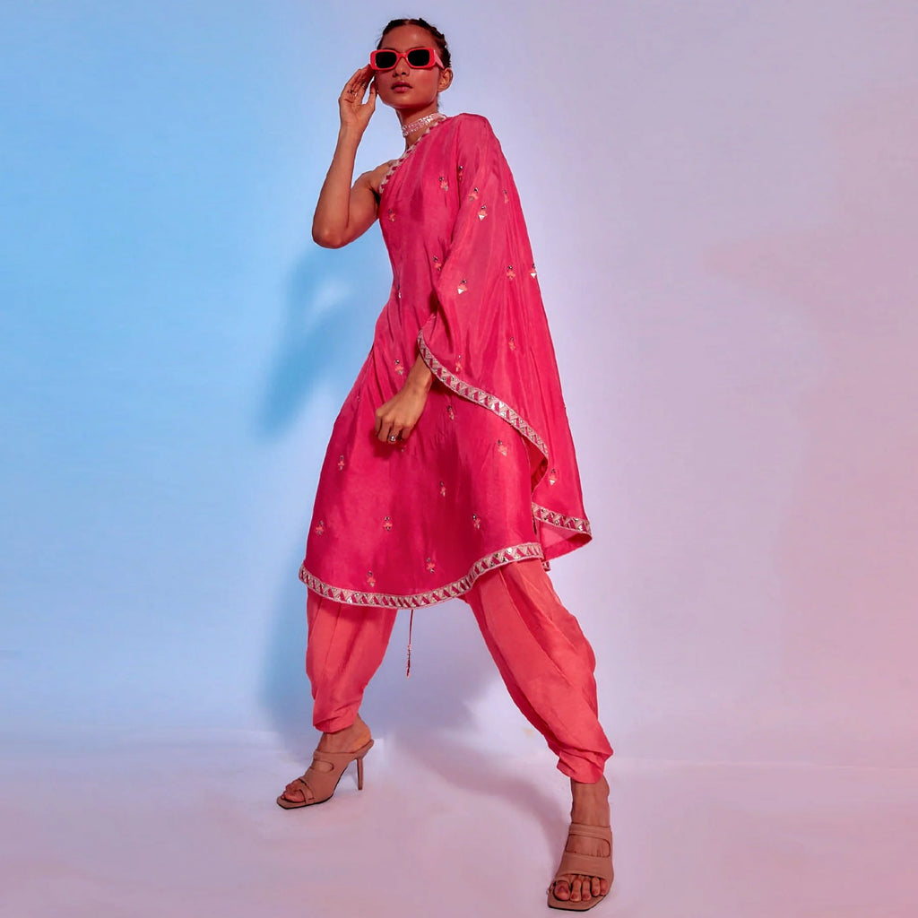 EMBELLISHED CORAL ONE SHOULDER DRAPED KURTA TEAMED WITH CORAL DRAPED PANTS