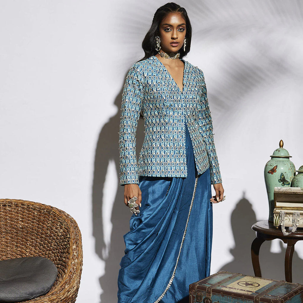 TURQUOISE BLUE DRAPE SKIRT WITH ATTACHED DRAPE PAIRED WITH EMBELLISHED STRUCTURE JACKET