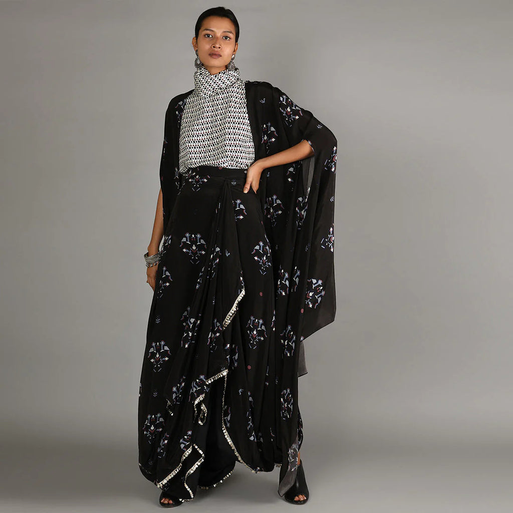 JAALI PRINT WHITE TURTLE NECK TOP PAIRED WITH BLACK BIRD PRINT DRAPE SKIRT WITH CAPE