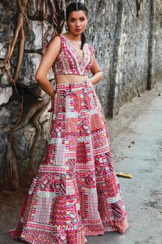 THREADWORK EMBELLISHED CHEVRON LEHENGA TEAMED WITH A COLOUR BLOCKED EMBELLISHED CAPE AND BUSTIER