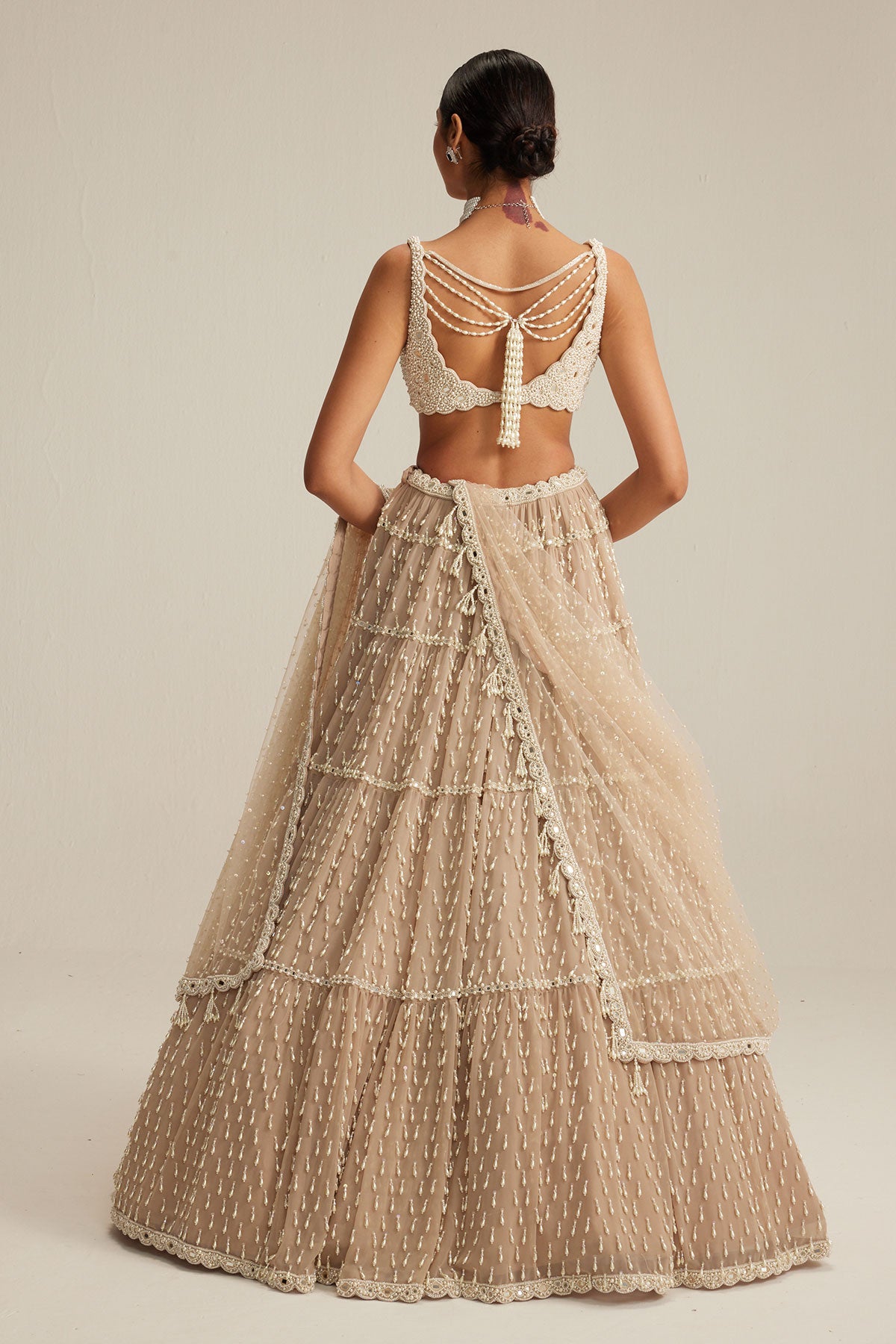 Light Beige Pearl Drop Multi Tier Lehenga Set.