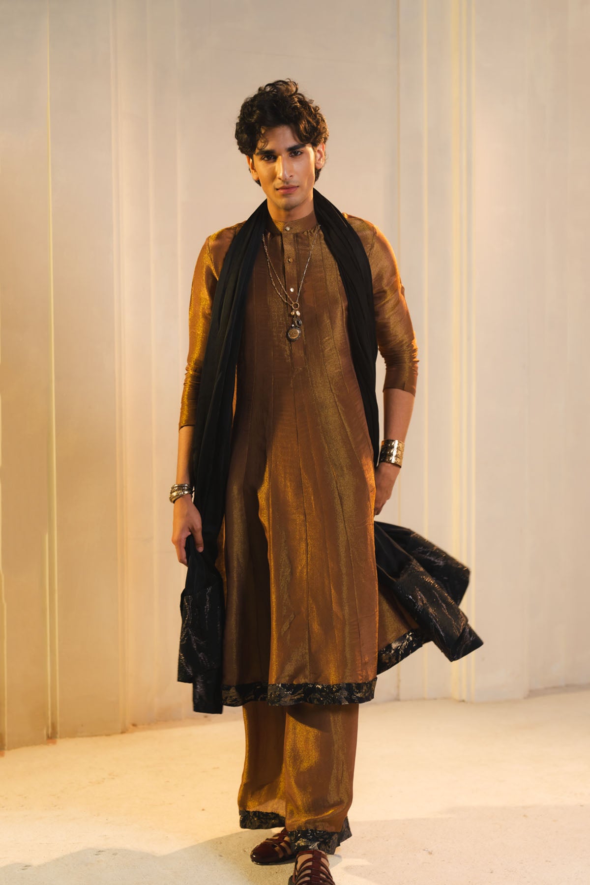 Anarkali Kurta In Gold, Paired With Flared Trousers And A Contrasting Black Dupatta.
