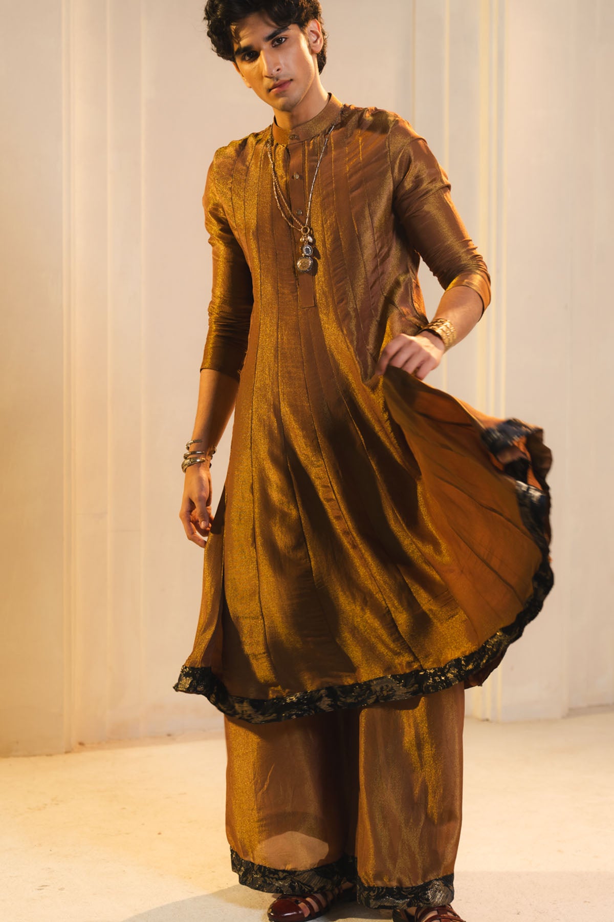 Anarkali Kurta In Gold, Paired With Flared Trousers And A Contrasting Black Dupatta.