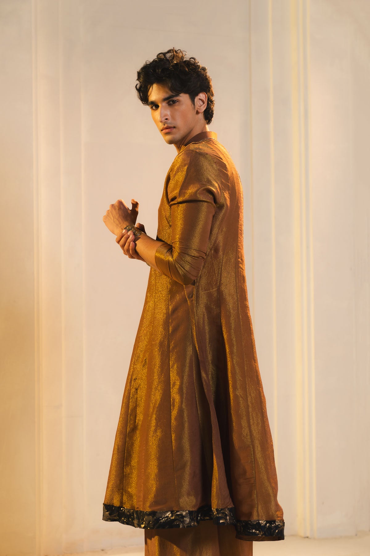 Anarkali Kurta In Gold, Paired With Flared Trousers And A Contrasting Black Dupatta.