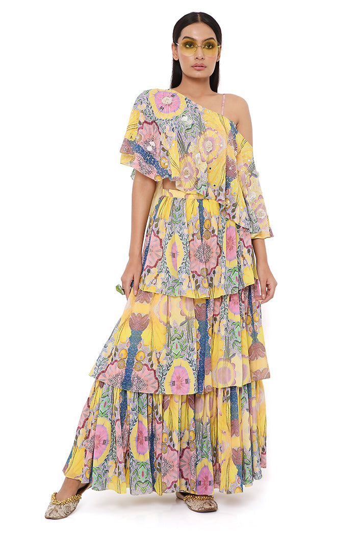 YELLOW ENCHANTED PRINT GEORGETTE EMBROIDERED ONE SHOULDER CAPE WITH BUSTIER AND FRILL SHARARA