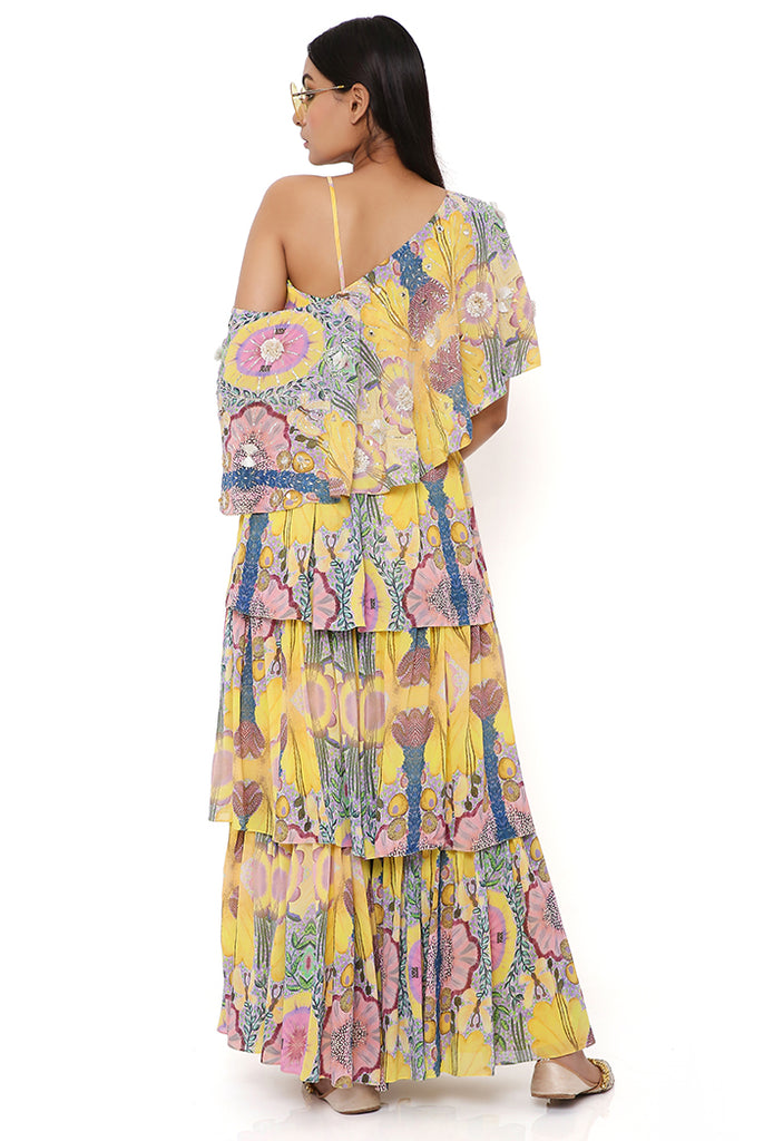 YELLOW ENCHANTED PRINT GEORGETTE EMBROIDERED ONE SHOULDER CAPE WITH BUSTIER AND FRILL SHARARA
